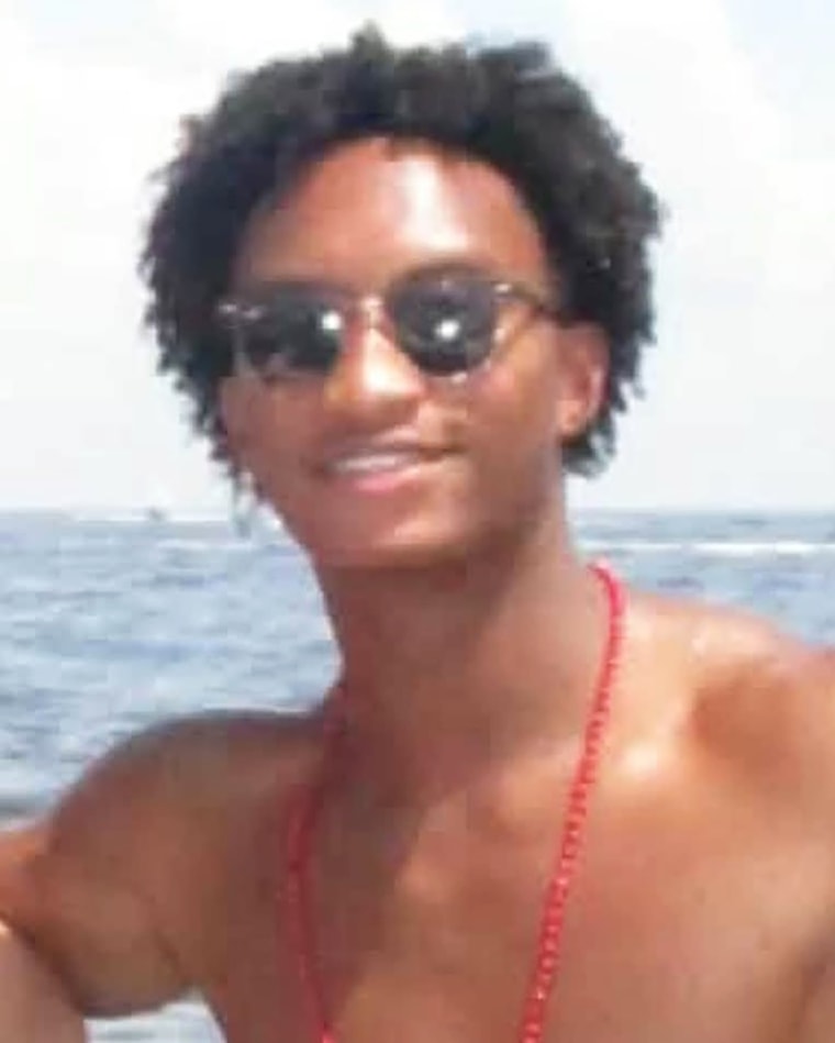 Nolan Xavier Wells outside on a boat smiling for a photo