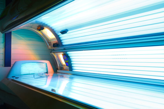 Image: switched on open tanning bed with face tanner
