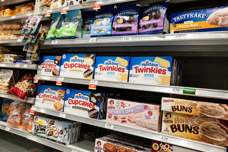 Desserts on rows of grocery store shelfs. Hostess, TastyKake, and Little Debbie packaged sweets can be seen