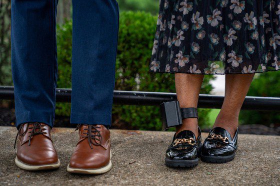 A person wears an ankle monitor