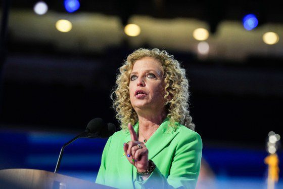 Debbie Wasserman Schultz speaks at a podium in an arena