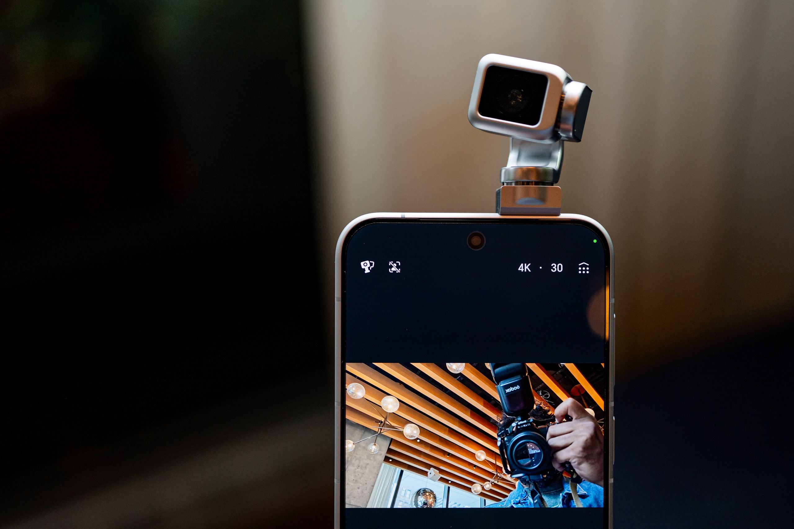 Image may contain Photography Electronics Phone Mobile Phone Baby Person and Camera