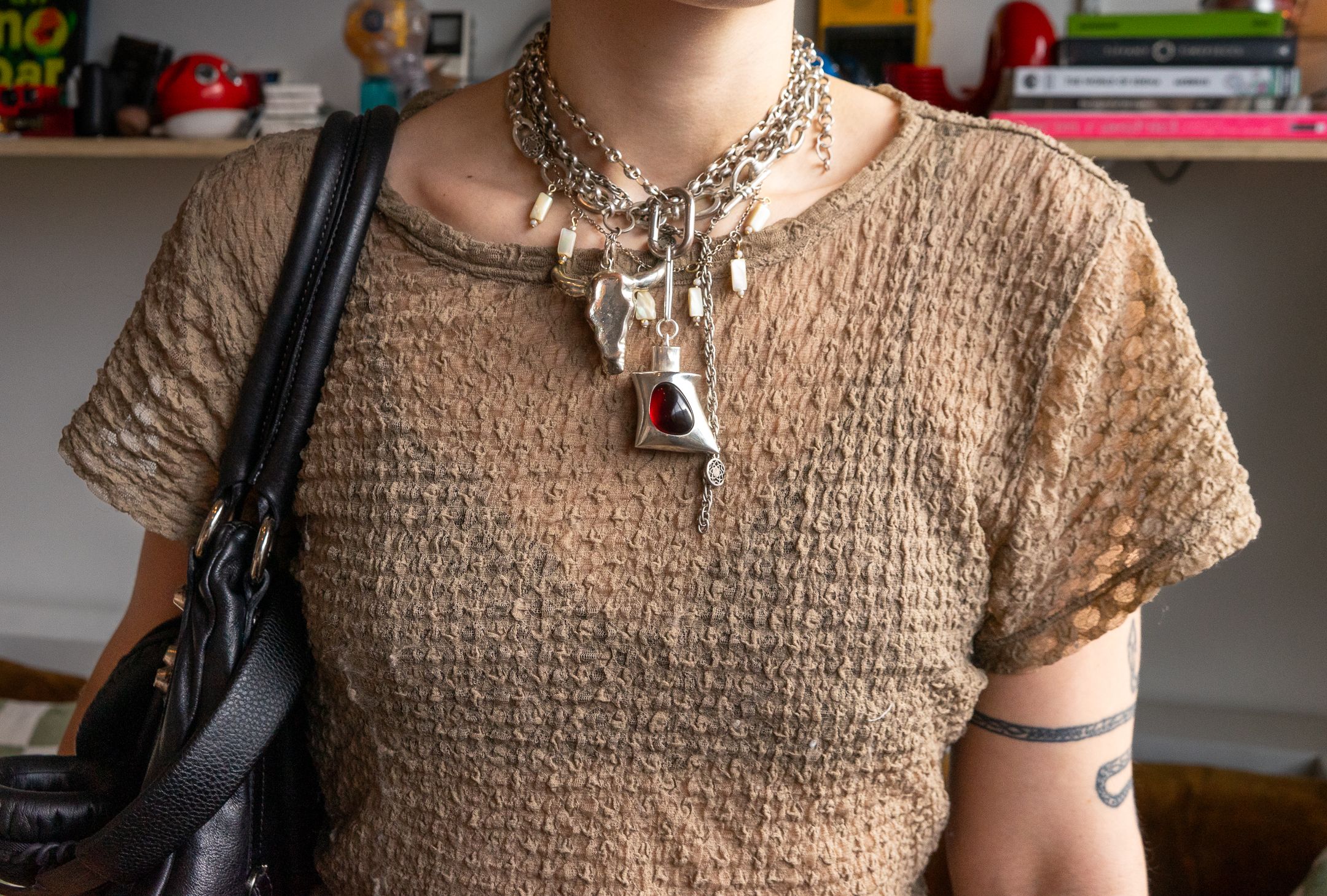 Image may contain Accessories Jewelry Necklace Clothing Sleeve Pendant Adult and Person