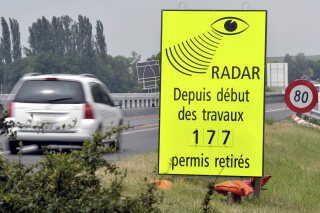A vehicle passes in front of a sign of the Vaud Cantonal Police indicating the number of driving licences withdrawn for speeding in the construction zone on the A1 motorway between Lausanne and Yverdon, Switzerland, Tuesday, June 15, 2010. (Dominic Favre/Keystone via AP, file)