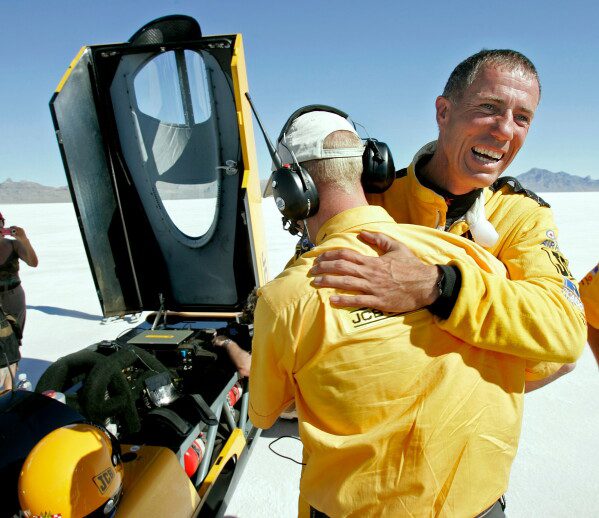British driver Andy Green, right, is congratulated by a crew member after setting a new unofficial world diesel powered land speed record of over 328 mph over two runs on the Bonneville Salt Flats in Utah on Tuesday, Aug. 2006. (AP Photo/Douglas C. Pizac, File)