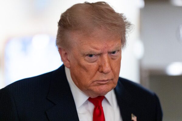 President Donald Trump speaks with reporters while on Air Force One en route to Oakland County International Airport, July 27, 2026, in Waterford Township, Mich. (AP Photo/Alex Brandon, File)