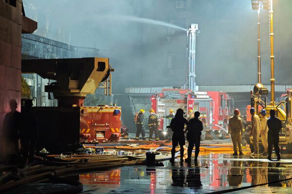 In this photo released by Xinhua News Agency, firefighters work at the scene of a footwear factory fire in Jiangtou village, Chendai township of Jinjiang city, southeastern China's Fujian province, on Thursday, July 9, 2026. (Zhou Yi/Xinhua News Agency via AP)