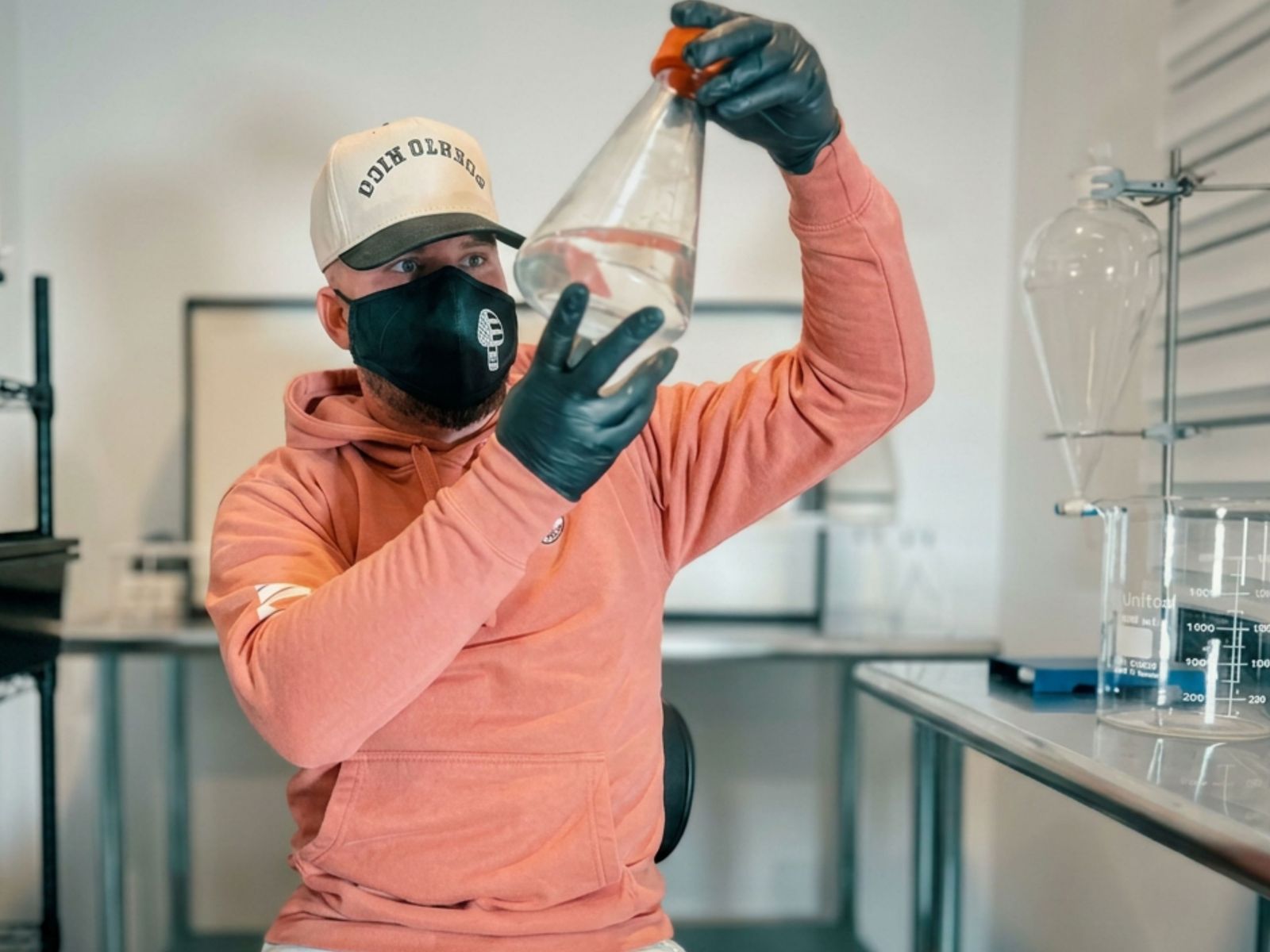 Man holding up a beaker
