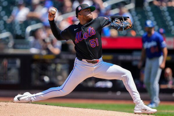 New York Mets pitcher Freddy Peralta (51) throws during the first inning of a baseball game against the Los Angeles Dodgers, Sunday, July 26, 2026, in New York. (AP Photo/Yuki Iwamura)