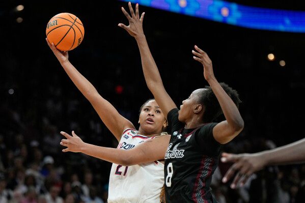 UConn forward Sarah Strong (21) shoots over South Carolina forward Joyce Edwards (8) during the second half of a woman's NCAA college basketball tournament semifinal game at the Final Four, April 3, 2026, in Phoenix. (AP Photo/Ross D. Franklin, File)