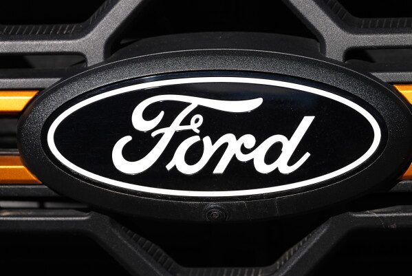 A Ford logo is seen on the grille of an unsold vehicle at a Ford dealership, Nov. 2, 2025, in Littleton, Colo. (AP Photo/David Zalubowski, File)