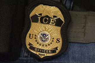 A federal agent wears an Immigration and Customs Enforcement badge in New York, June 10, 2025. (AP Photo/Yuki Iwamura, File)