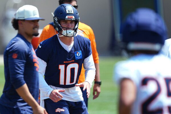 Denver Broncos quarterback Bo Nix takes part in drills at the team's NFL football training camp Wednesday, Aug. 12, 2026, in Centennial, Colo. (AP Photo/David Zalubowski)