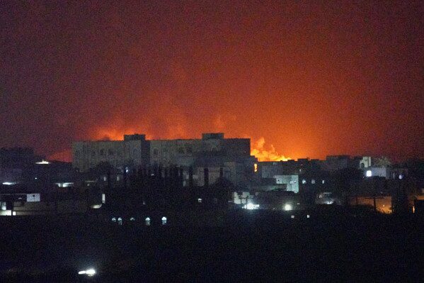 Flames and smoke rise from the port of Mokha during a strike in Yemen, Friday, Aug. 14, 2026. (AP Photo/Abdulnasser Alseddik)
