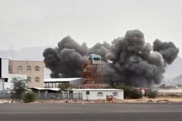 This image taken from video broadcast by Al-Masirah TV, a Houthi-controlled news channel, shows an explosion at the Sanaa International Airport compound during what the Iranian-backed Houthi rebels in Yemen said were several Saudi airstrikes in Sanaa, Yemen, July 13, 2026. (Al-Masirah TV via AP, File)