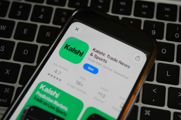 An ad for the prediction market app Kalshi is displayed on a mobile phone Thursday, April 16, 2026, in Chicago. (AP Photo/Erin Hooley,File)
